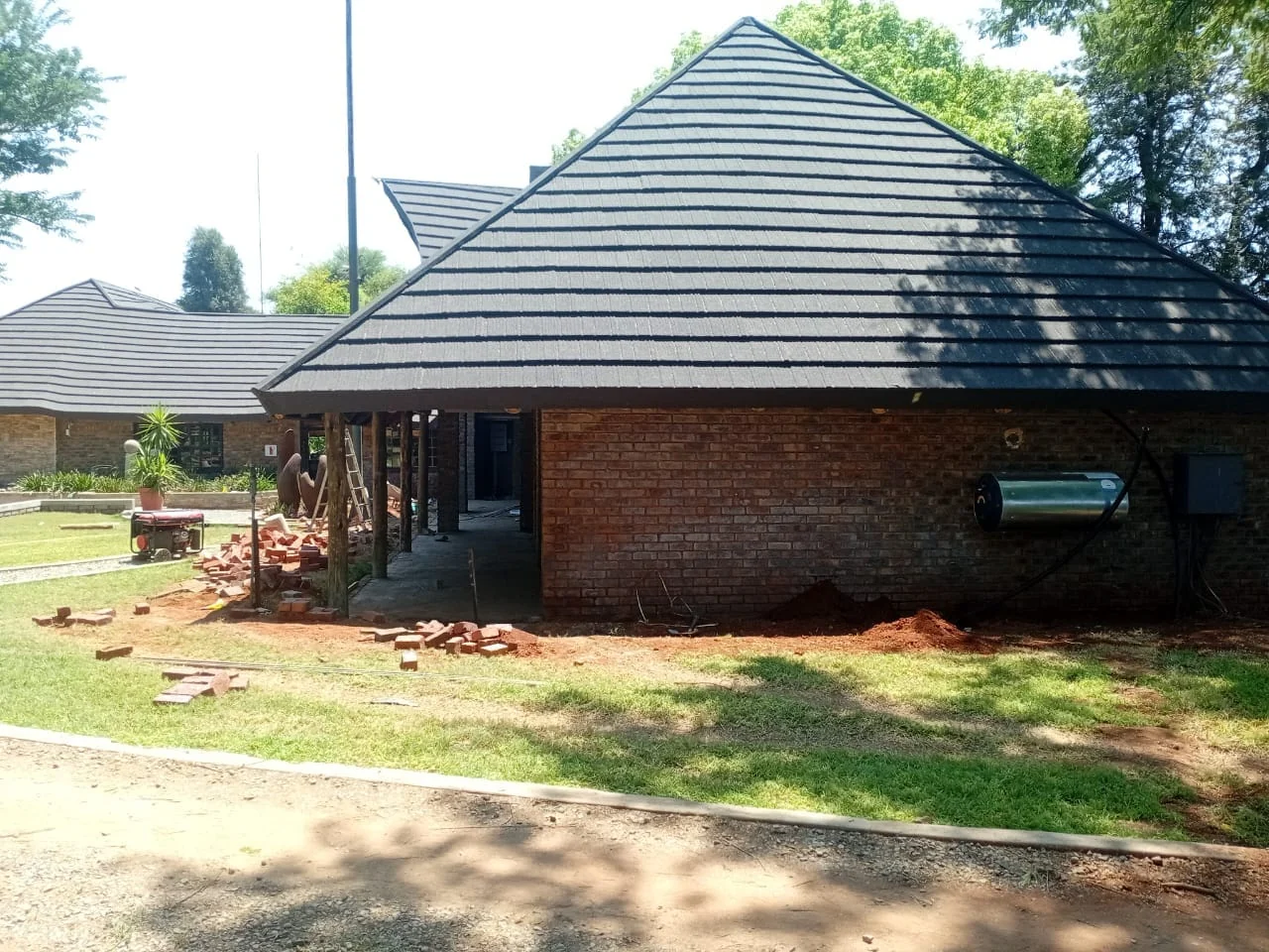 Skilled roofing workers installing tiles on a construction site