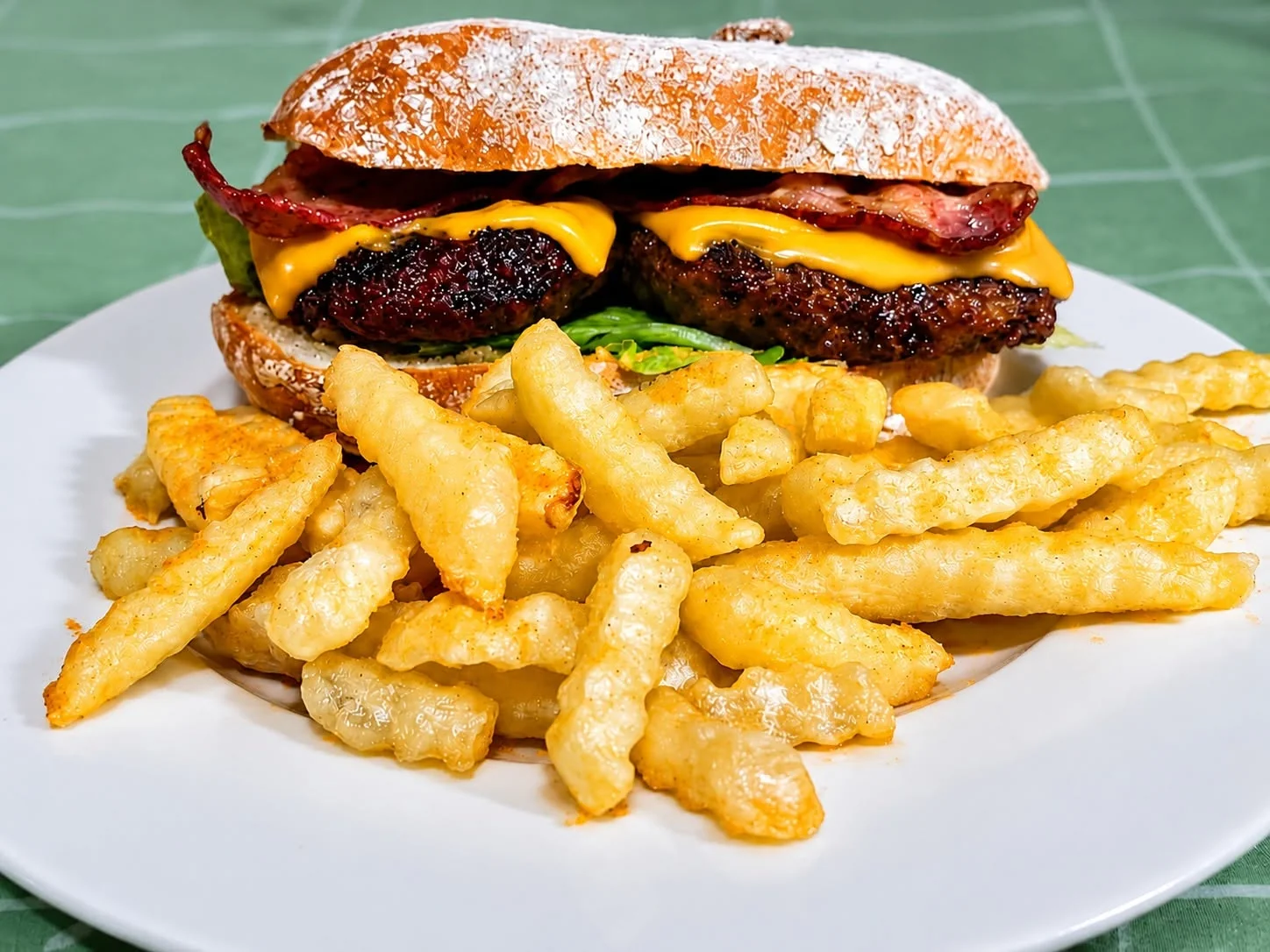 Chef's hand pressing a burger patty, demonstrating handcrafted quality